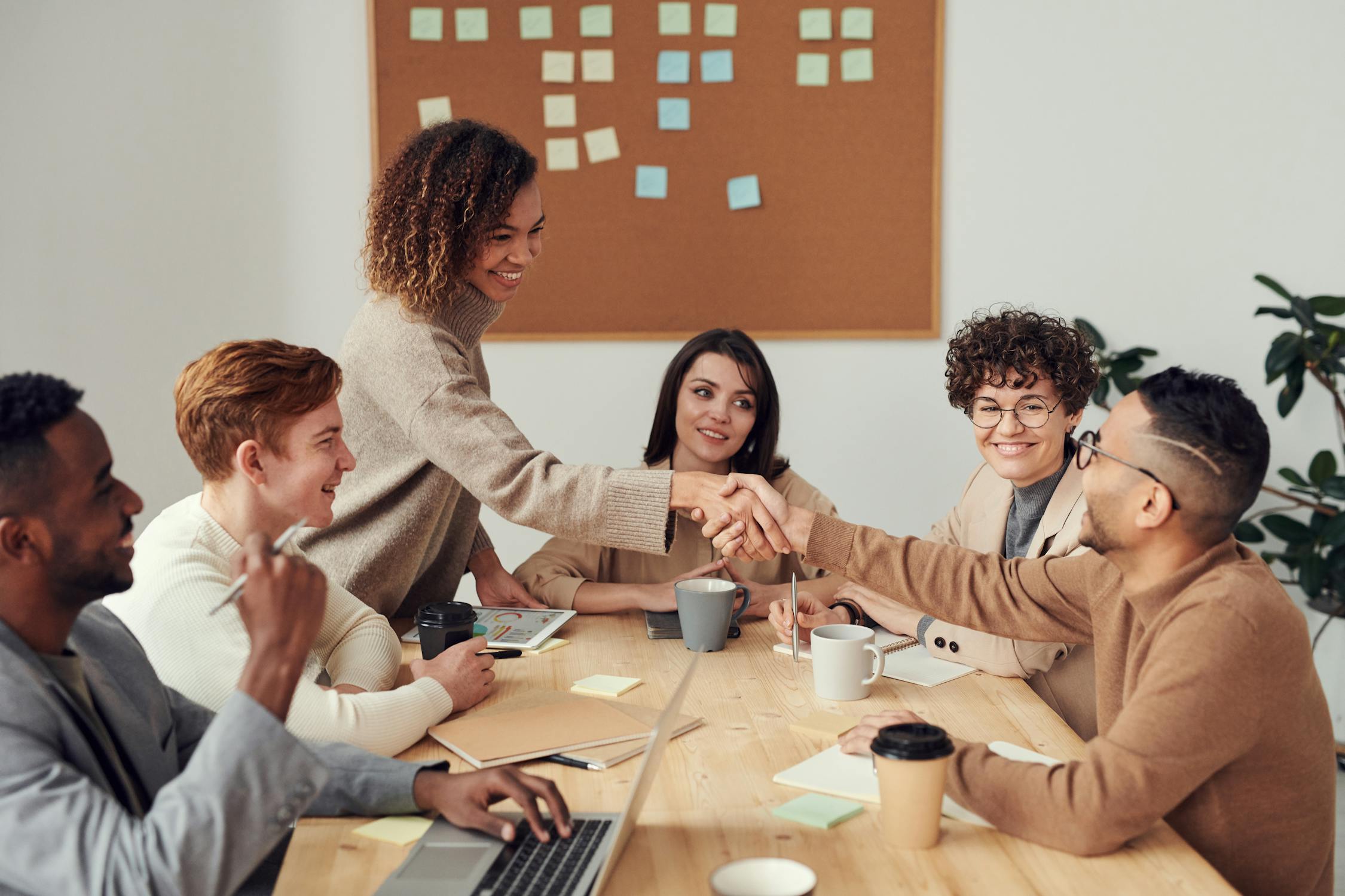 Professional team collaborating in modern office with digital interfaces